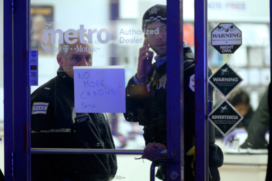 Zwei Polizisten stehen in einem Handy-Geschäft in der Nähe des Tatorts in Chicago.