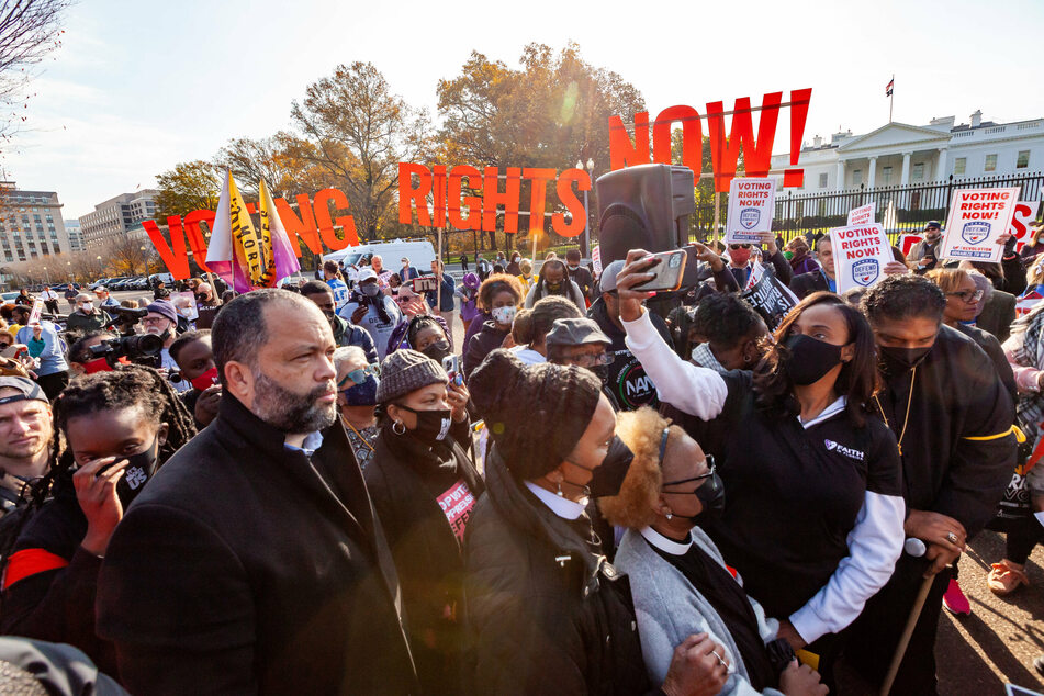 Votings rights activists rally in front of the White House to demand the passage of legislation to expand ballot access.