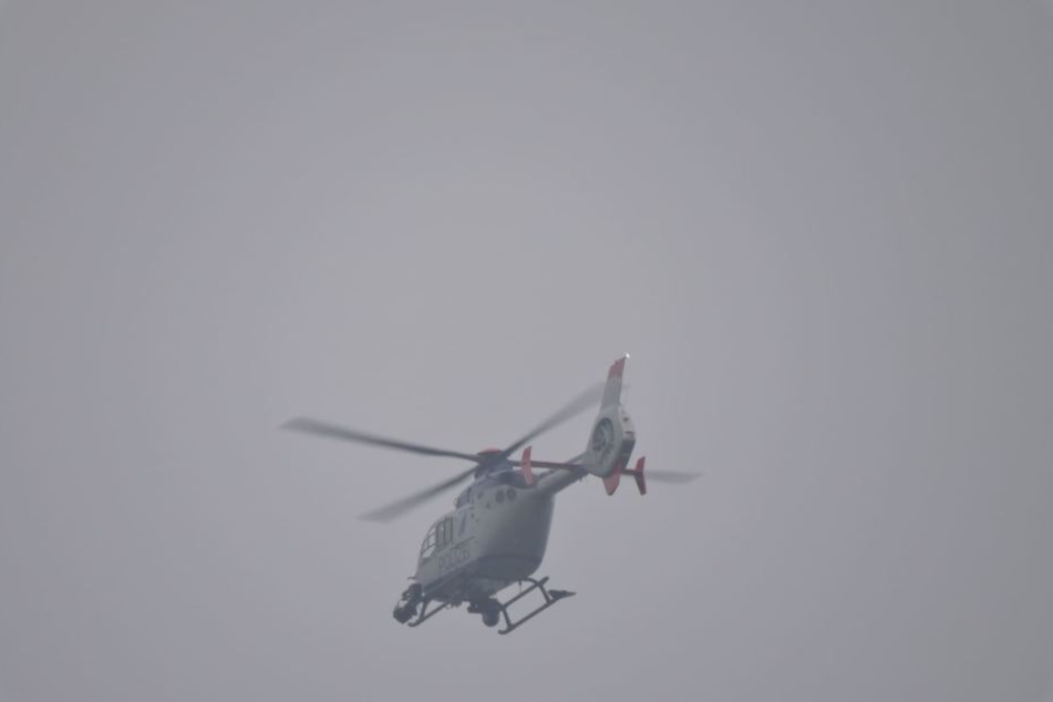 Ein Hubschrauber beobachtet das Geschehen in Zwenkau aus der Luft.