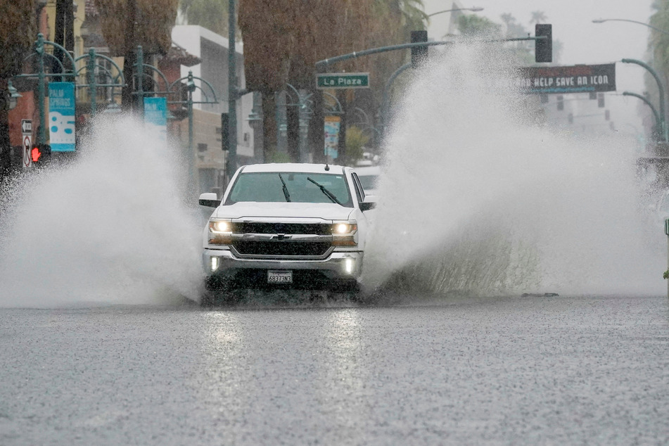 A truck moves through standing water as Tropical Storm Hilary approaches Palm Springs, California.
