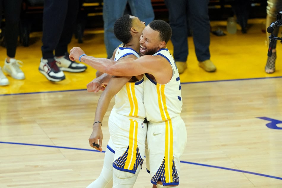 Jordan Poole and Steph Curry celebrate during the Warriors' win over the Celtics.