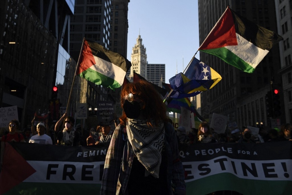 Protesters raise Palestinian flags during a demonstration in support of reproductive justice, LGBTQ+ rights, and a permanent ceasefire in Gaza on the eve of the Democratic National Convention in Chicago, Illinois.