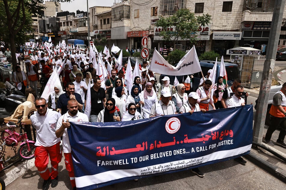 Palestinian Red Crescent crews hold a rally on World Red Cross and Red Crescent Day in Ramallah in the occupied West Bank on May 12, 2025.