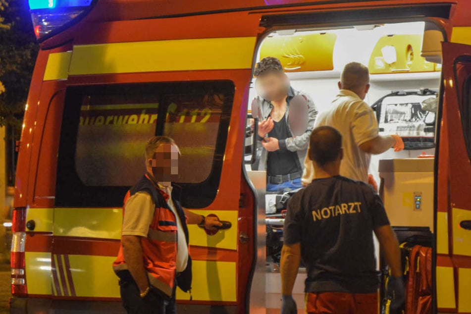 Blutverschmiert steht ein Mann im Rettungswagen auf dem Hasselbachplatz. Ein 44-jähriger Türke wurde bei der Auseinandersetzung schwer verletzt.