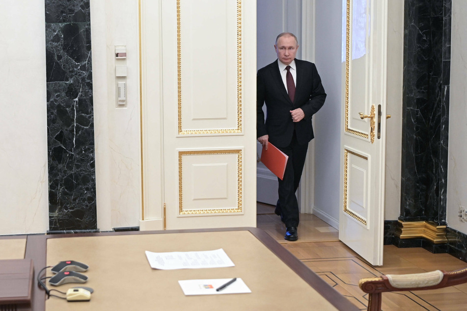 Russian President Vladimir Putin arrives for a conference call with members of his security council.