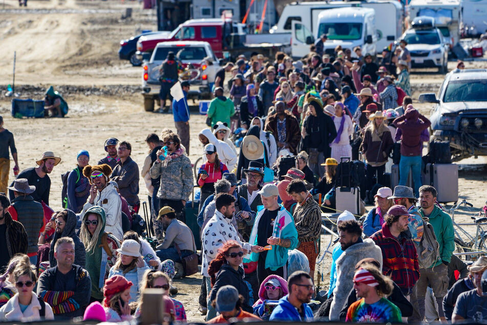 Burning Man festival attendees begin exodus in drenched desert