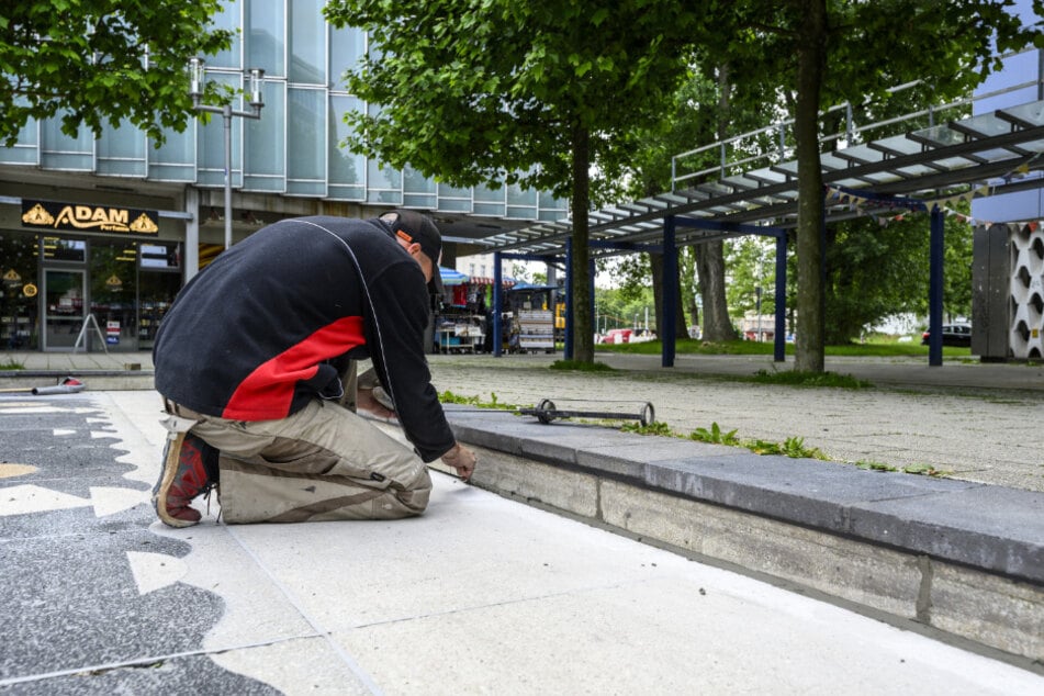 Michael Röhner (49) beim Reparieren der Platten im Brunnen am Rosenhof.