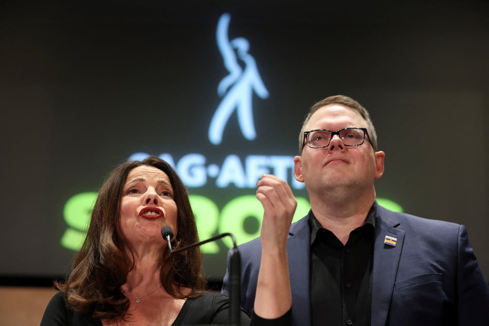 SAG-AFTRA President Fran Drescher speaks to the media, next to the union's chief negotiator Duncan Crabtree-Ireland, after the SAG-AFTRA TV/Theatrical Committee approved a tentative agreement with the Alliance of Motion Picture and Television Producers to bring an end to the actors' strike.