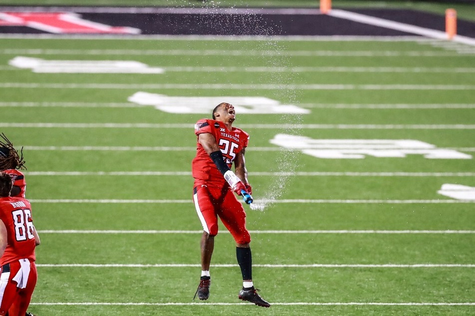 Defensive back Dadrion Taylor-Demerson of the Texas Tech Red Raiders celebrates on the field after a win against the Baylor Bears.