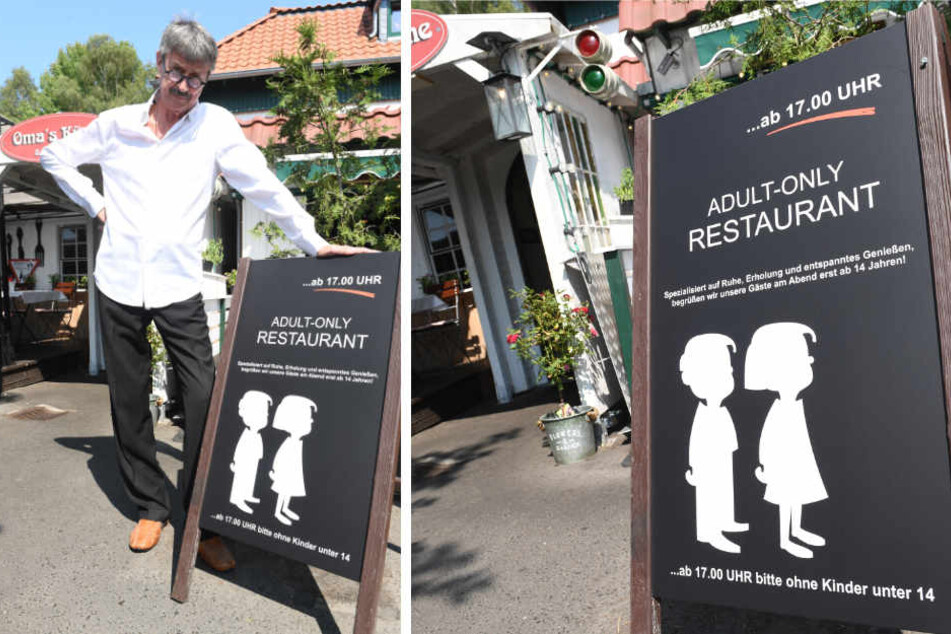 Ein Schild mit der Aufschrift “Adult-Only Restaurant ...ab 17.00 Uhr bitte ohne Kinder unter 14" steht vor dem Eingang des Restaurants "Oma's Küche".
