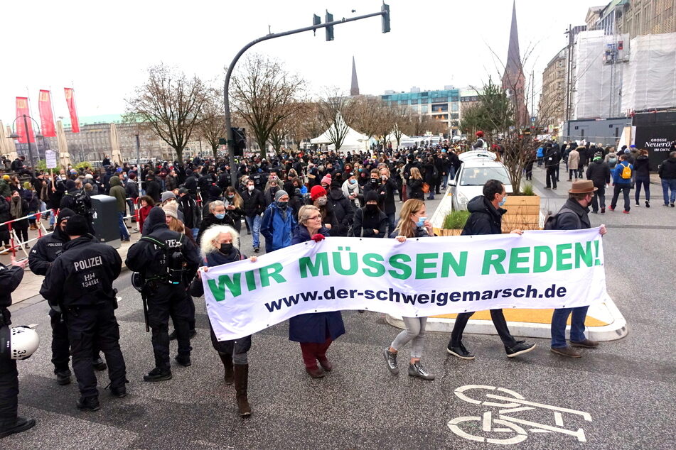 "Wir müssen reden!" steht auf einem Plakat der Demonstranten am Jungfernstieg.