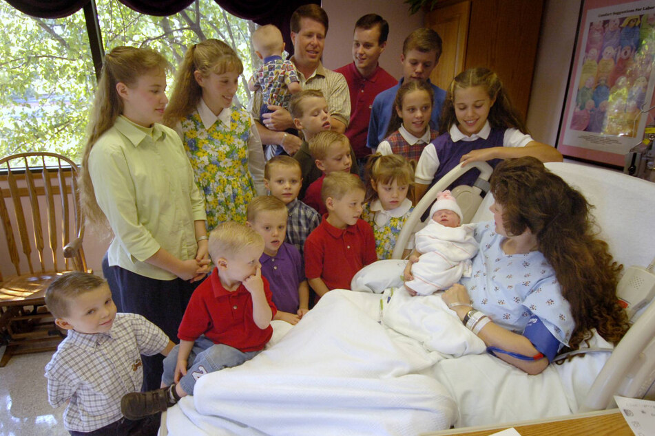 Josh (back, second from right, next to his father Jim Bob), with his family in 2005 as they welcome the 16th sibling on the TV program about their large family. (Archive image)