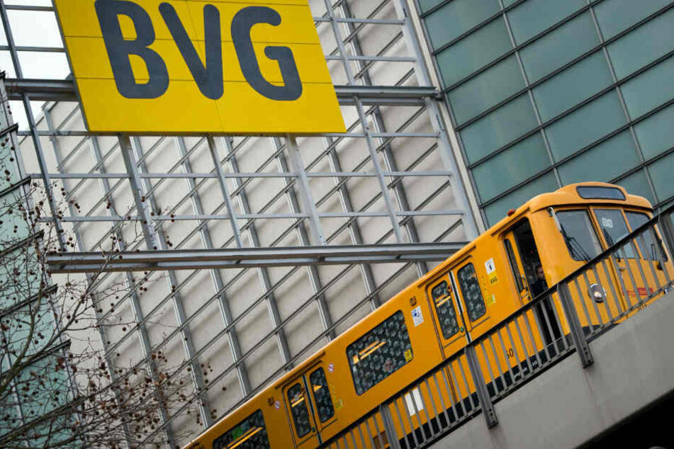 Die U-Bahn fährt unter einem Schild der BVG vorbei.