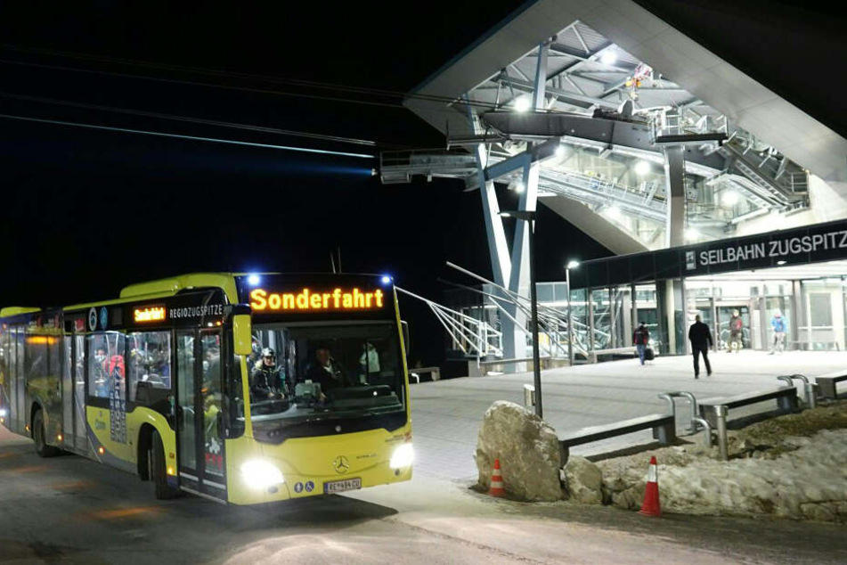 Busse holen gerettet Passagiere an der Station der Zugspitzbahn ab.