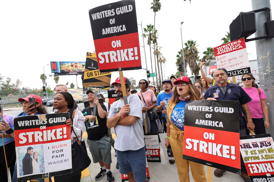 SAG-AFTRA actors and Writers Guild of America (WGA) writers walk the picket line during their ongoing strike outside Netflix offices in Los Angeles, California.