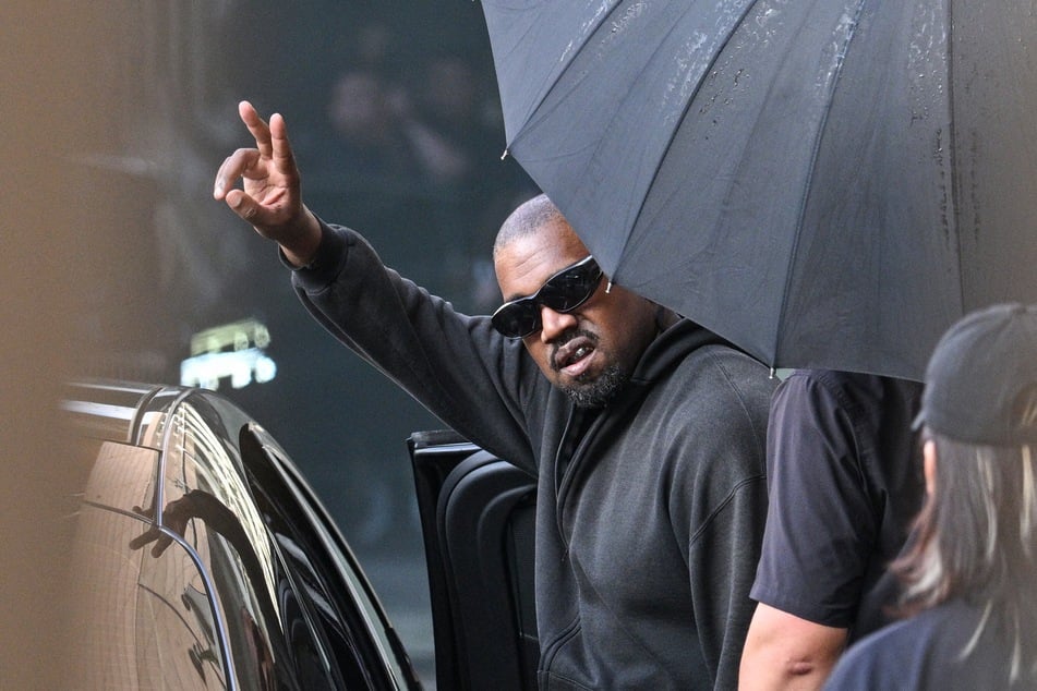 Rapper and producer Kanye West gestures upon arriving at Shanghai Pudong International Airport on July 11, 2025.