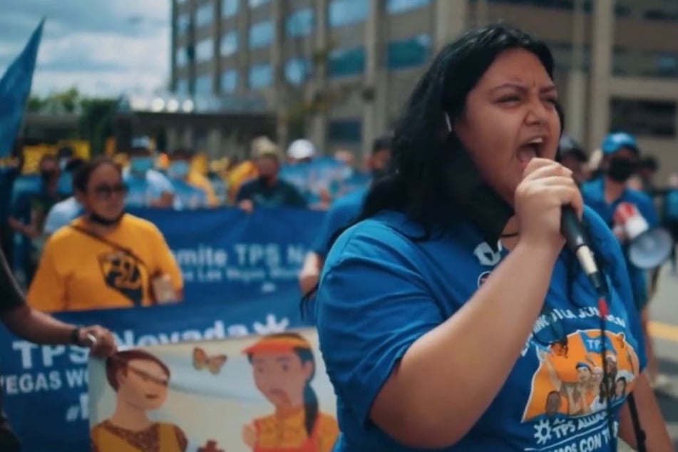 Rebecca Vasquez takes the mic at a rally for TPS Justice as the future status of TPS holders from Central America and Nepal remains uncertain.