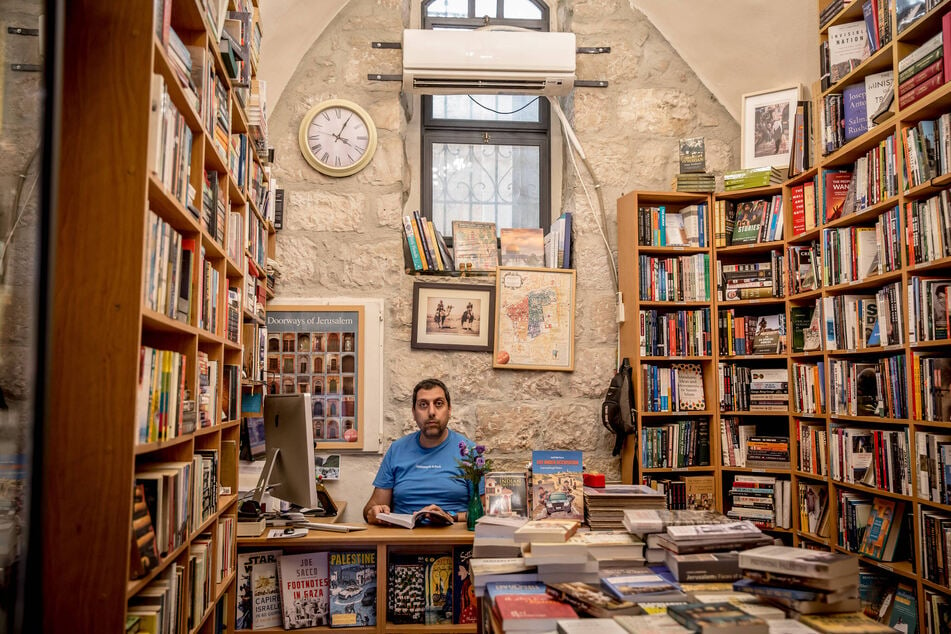 Mahmud Muna, one of the owners of East Jerusalem's historic Educational Bookshop, is pictured inside a branch of the store.