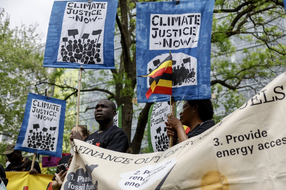 Climate activists rally against fossil fuels outside of the World Bank and International Monetary Fund headquarters in Washington DC.