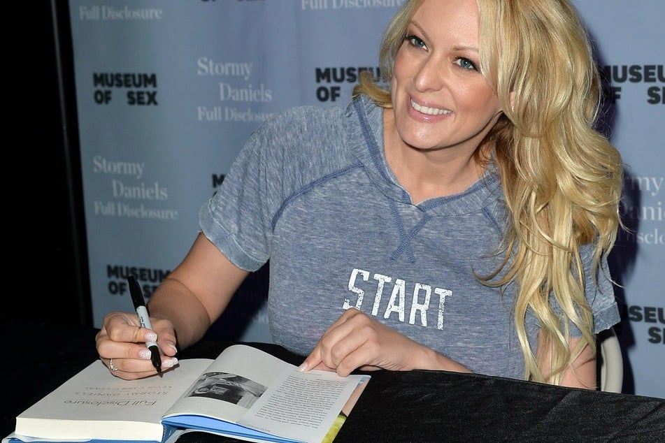 Stormy Daniels signing copies of her book, Full Disclosure, which became the focus of the fraud trial.
