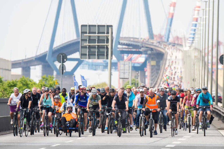 Teilnehmer einer Fahrradsternfahrt fahren mit ihren Fahrrädern über die Köhlbrandbrücke.