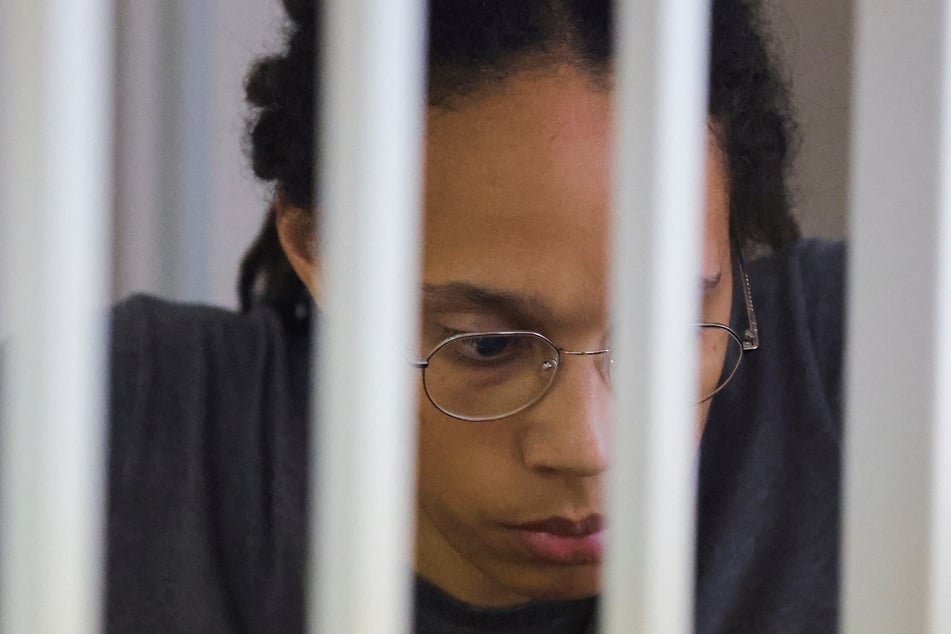 US basketball player Brittney Griner sits inside a defendants' cage after the court's verdict in Khimki outside Moscow, Russia, on August 4, 2022.
