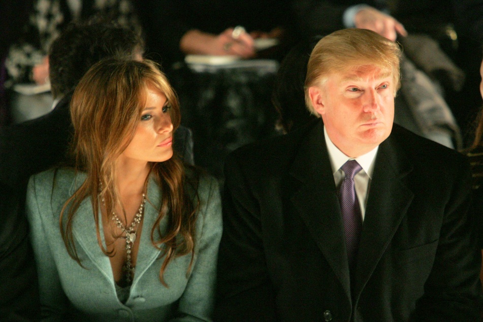 Donald Trump (r.) and his wife Melania Trump attending the Michael Kors Fall 2005 fashion show at Bryant Park in New York City on February 9, 2005.