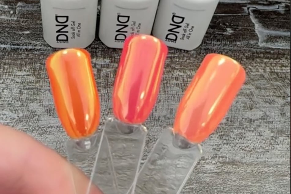 Orange-you excited for this chrome design? TikToker @dailybeautyinspo shows us how to achieve a unicorn nail look this summer.