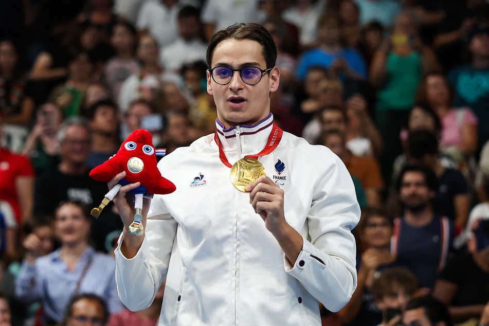 Gold medalist France's Ugo Didier celebrates on the podium of the men's S9 400m freestyle swimming event during the Paris 2024 Paralympic Games at The Paris La Defense Arena in Nanterre, west of Paris on Thursday.