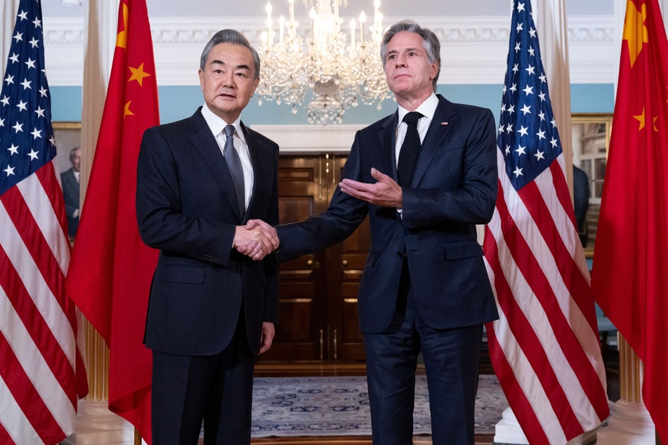 US Secretary of State Antony Blinken shakes hands with Chinese Foreign Minister Wang Yi on October 26, prior to meetings at the State Department in Washington DC.