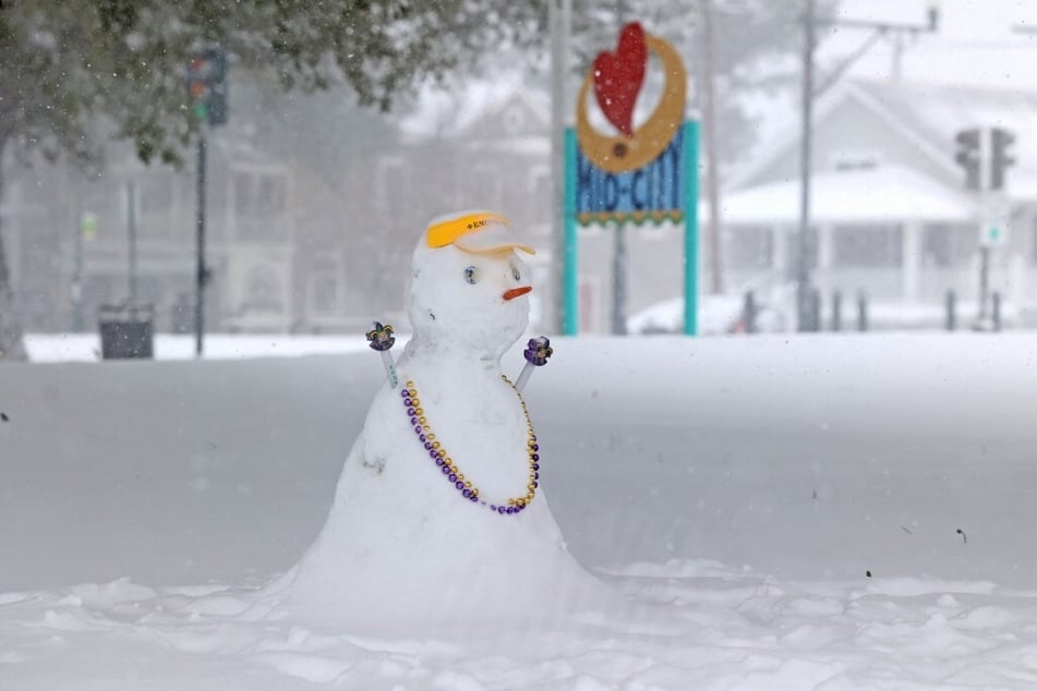 A snowman wearing Mardi Gras throws is pictured on Orleans Avenue in the Mid-City neighborhood of New Orleans, Louisiana, during a snow storm on January 21, 2025.