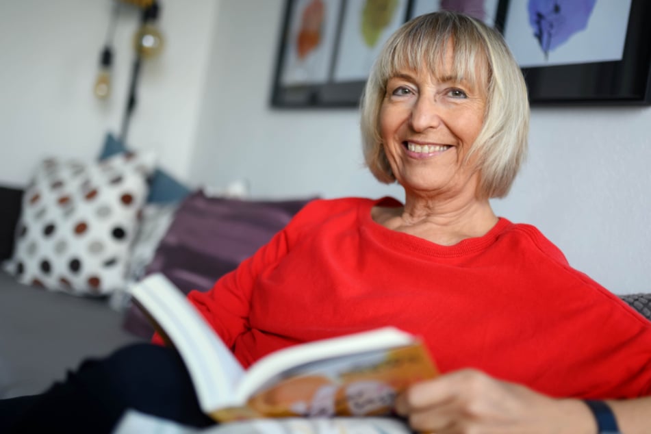 Monika Wehn liest ein Buch in ihrer Wohnung.