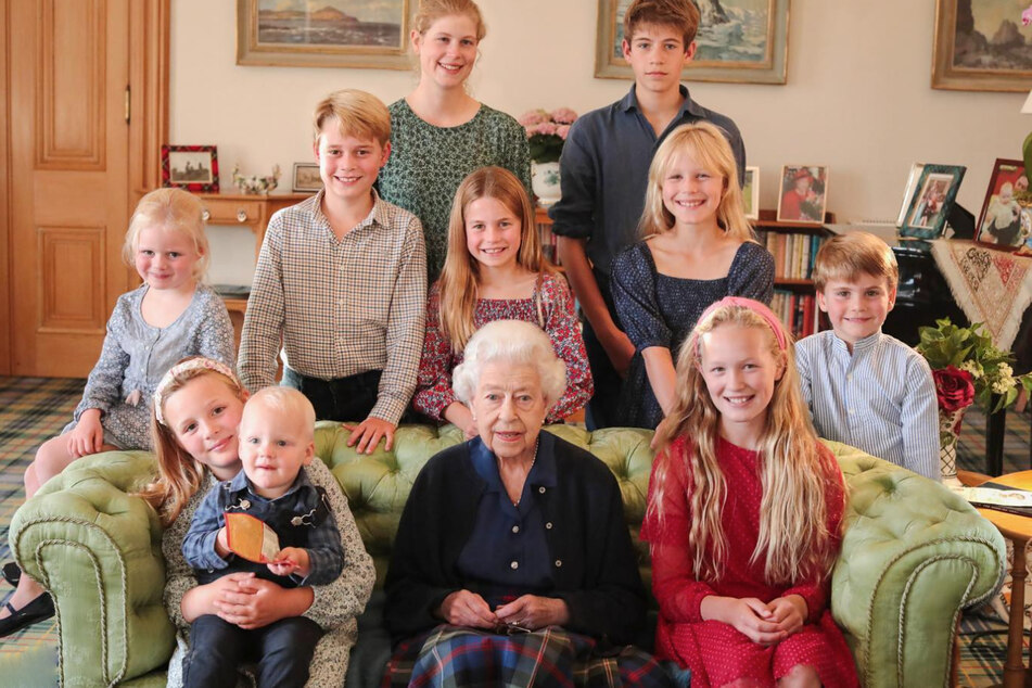 The apparently doctored photo shows the late queen surrounded by her grandchildren and great-grandchildren.
