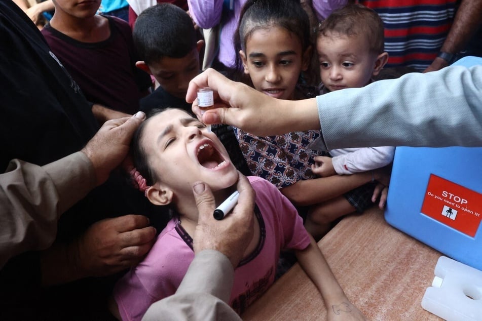 Palestinian children receive drops as part of a polio vaccination campaign in Deir al-Balah in the central Gaza Strip on October 14, 2024.