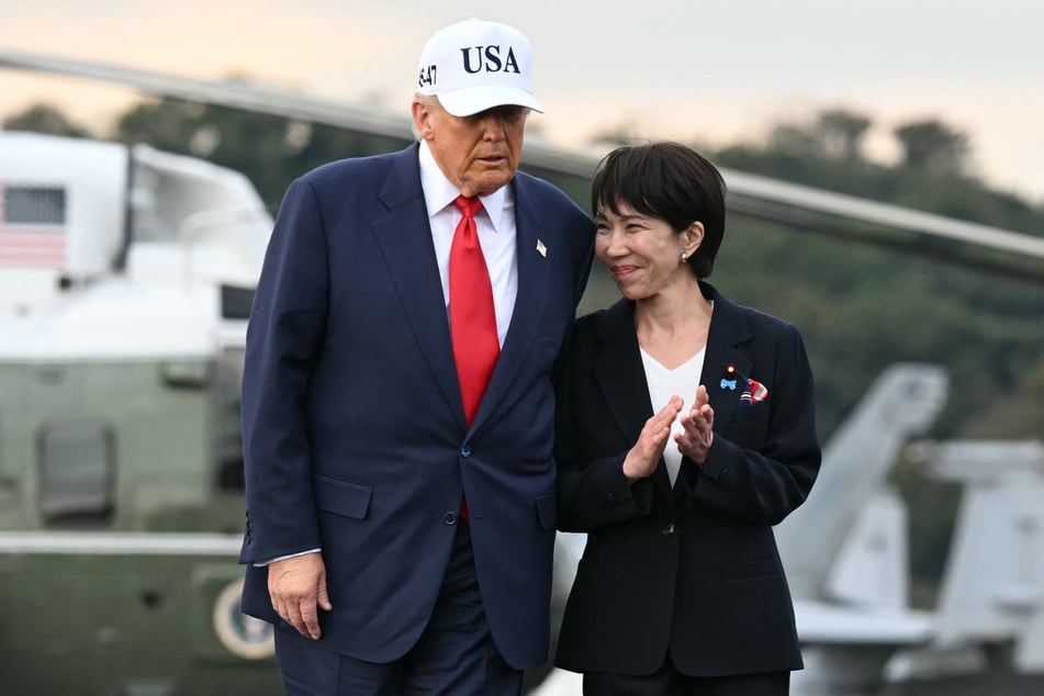 President Donald Trump (l.) and Japan's Prime Minister Sanae Takaichi arrive on board the US Navy's USS George Washington aircraft carrier at the US naval base in Yokosuka on October 28, 2025.
