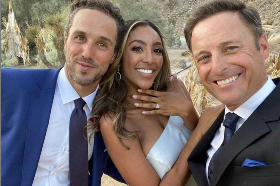 Chris Harrison (r.) poses with Tayshia Adams (c.) and her fiancé Zac Clark on Season 16 of The Bachelorette.