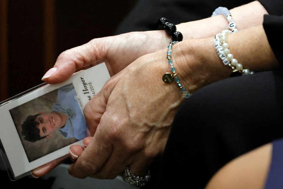 Gena Hoyer held a photo of her son, Luke, who was killed in the 2018 massacre, during the sentencing trial of Nikolas Cruz at the Broward County Courthouse on Thursday.