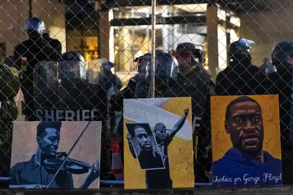 Paintings of Eljah McClain (l.) and George Floyd left by Black Lives Matter protestors.