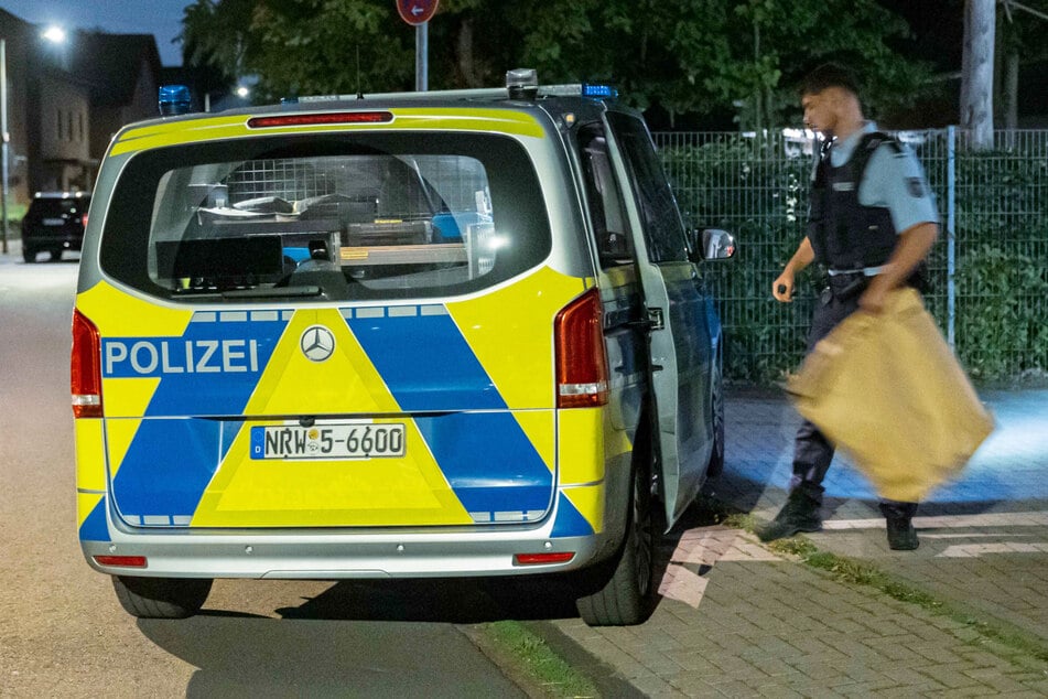 Die Polizei stellte mögliche Beweismittel in einer braunen Papiertüte sicher.