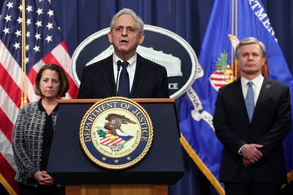 US Attorney General Merrick Garland (c.) speaks at a press conference on the Proud Boys conspiracy trial.