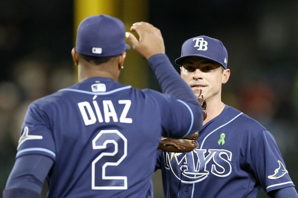 Yandy Diaz #2 and Brooks Raley #30 of the Tampa Bay Rays