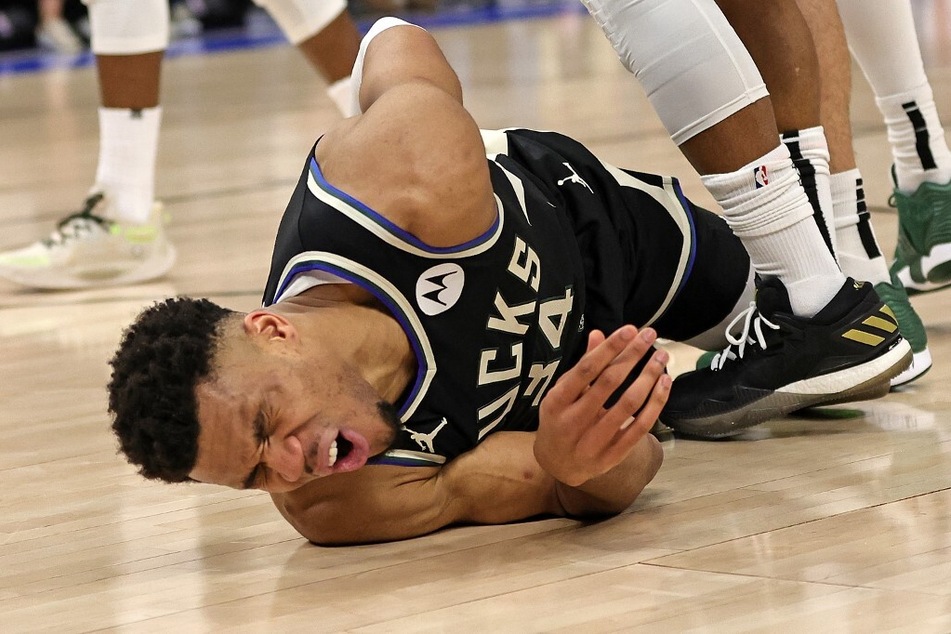 Giannis Antetokounmpo of the Milwaukee Bucks is injured during Game 1 of the Eastern Conference First Round Playoffs against the Miami Heat at Fiserv Forum.