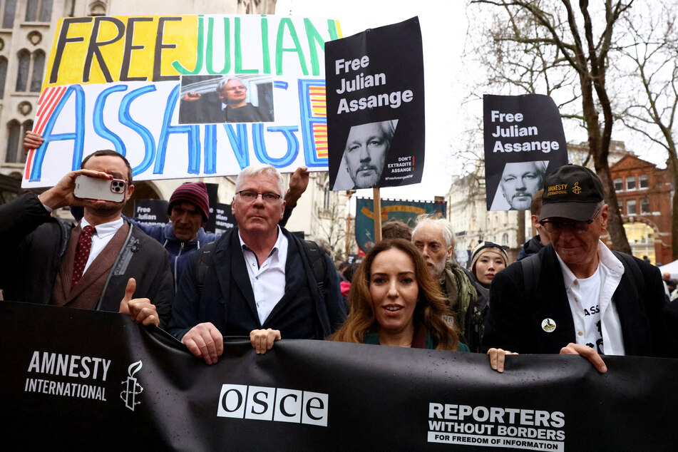 Stella Assange, the wife of WikiLeaks founder Julian Assange, and supporters of her husband march in London as Assange appeals against his extradition to the United States.