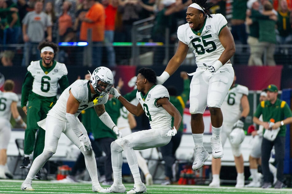 Baylor Bears offensive lineman Clayton Collier (r) jumps in celebration after winning the Big 12 championship.