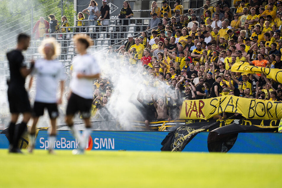 Die Anhänger protestierten mit Plakaten gegen den VAR und warfen Fischfrikadellen, Pyrotechnik sowie Tennisbälle auf den Platz.