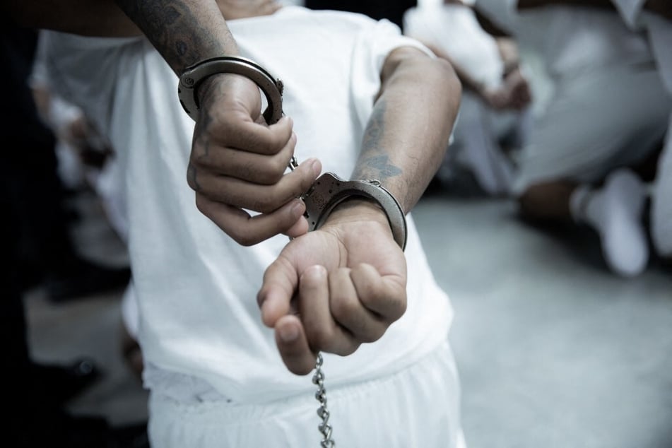 A person deported from the US is handcuffed upon arrival at the Terrorism Confinement Center in Tecoluca, El Salvador.