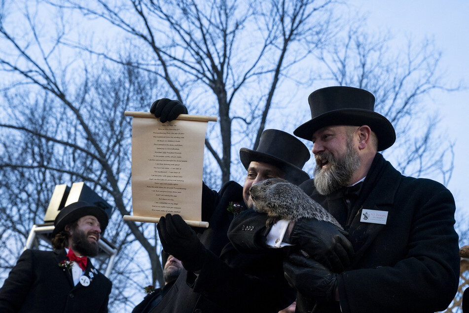 Groundhog handler AJ Derume holds Punxsutawney Phil, who saw his shadow, predicting a late spring at the 136th annual Groundhog Day festivities on February 2.