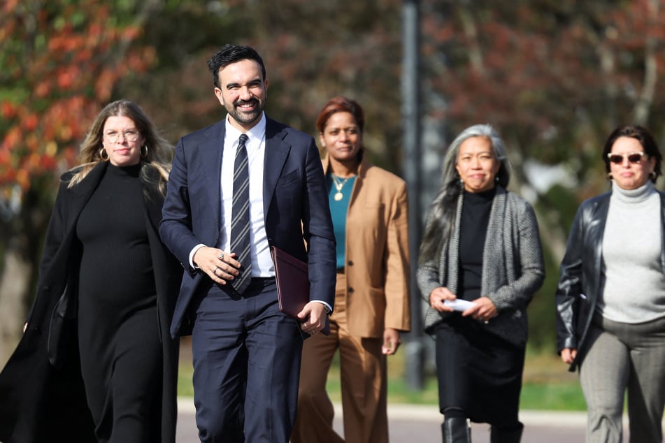 Zohran Mamdani walks with members of his transition team in Queens on November 5, 2025.