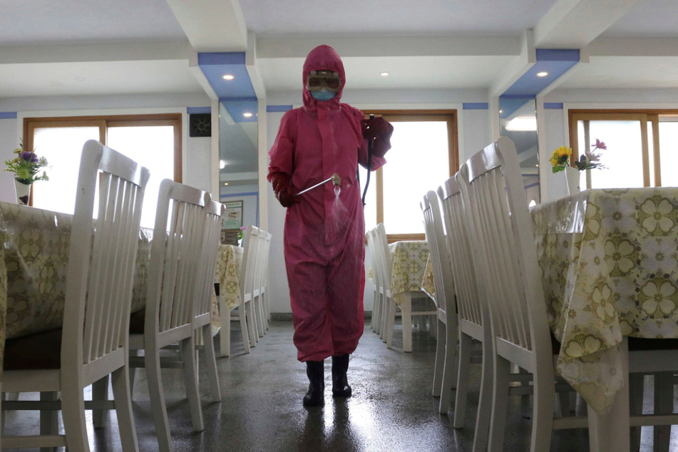 Eine Angestellte der Pjöngjang Dental Hygiene Products Factory desinfiziert den Boden eines Speisesaals, da der Staat die Maßnahmen zur Eindämmung der Ausbreitung von Krankheiten verstärkt hat.