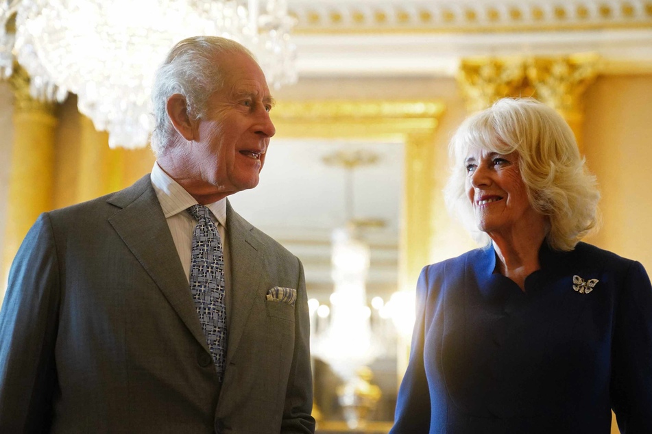 Britain's King Charles III (l.) and his wife Queen Camilla at Buckingham Palace on Wednesday.
